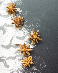 Scattered with powder and cinnamon on a black table. top view.