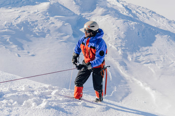 A climber with special equipment rises along the glacier to the highest peak