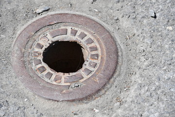 A hole in a manhole cover in downtown Montreal-Canada