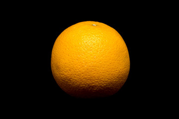 Studio shot of the whole orange isolated on black background