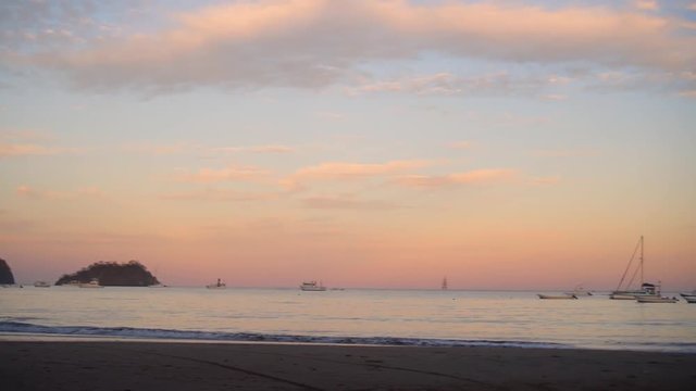 Sunrise Playas del Coco paning left to right with boats