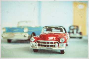 Vintage retro car. A stylized image imitating an old film photo with a faded color, vignetting, granularity.