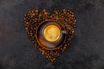 Coffee beans in shape of heart and espresso