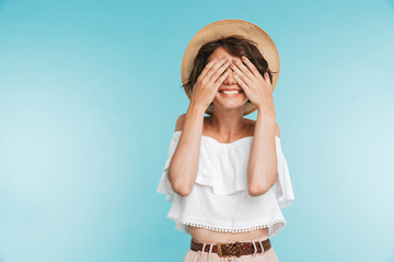 Portrait of a smiling young woman in summer hat
