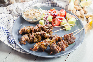 Traditional pork satay with peanut sauce and vegetables