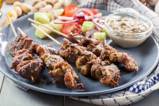 Traditional pork satay with peanut sauce and vegetables