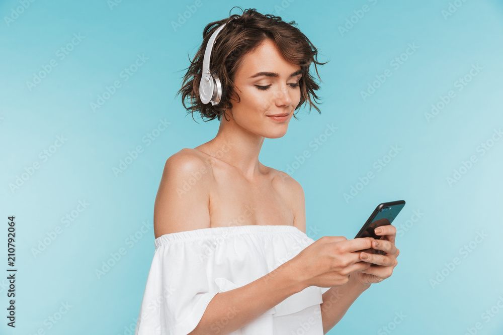 Canvas Prints Portrait of a pretty young woman listening to music