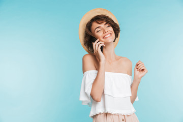 Portrait of a smiling young woman in summer hat