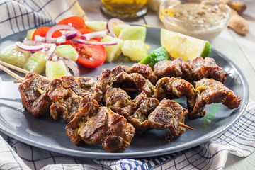 Traditional pork satay with peanut sauce and vegetables