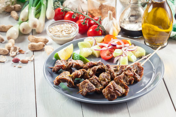 Traditional pork satay with peanut sauce and vegetables