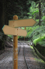 2 ways blank road signpost with forest railway road background