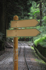 2 ways blank road signpost with forest railway road background