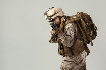 Soldier in camouflage holding rifle