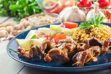Traditional pork satay with peanut sauce and vegetables