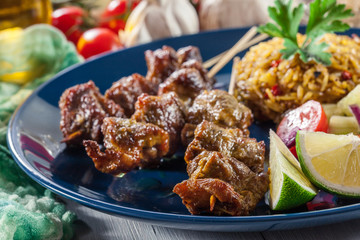 Traditional pork satay with peanut sauce and vegetables