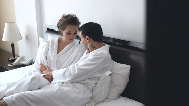 loving couple morning coats in bed
