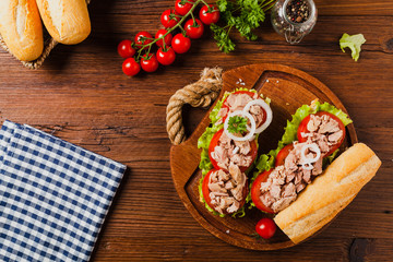 Delicious tuna sandwich, served with lettuce, tomato and onion. © gkrphoto