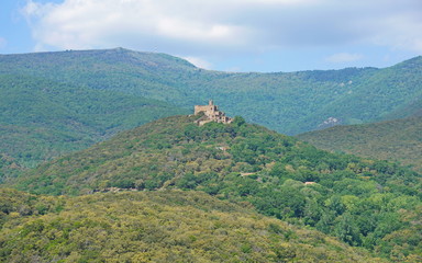 The castle of Requesens on the top of the hill with the peak Neulos in background, Albera massif, la Jonquera, Alt Emporda, Girona, Catalonia, Spain