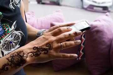 henna tattoo on women hands. Mehndi is traditional Indian decorative art. Close-up, overhead view - beauty and fashion concept