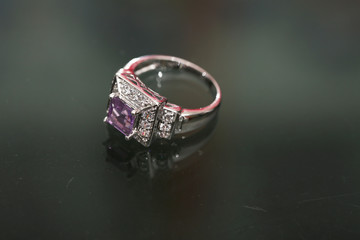 Purple gemstone on diamond ring