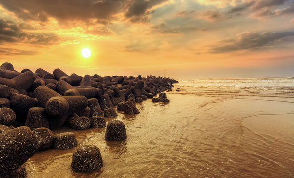 Sunrise at rocky sea beach at Digha Mohona West Bengal India.