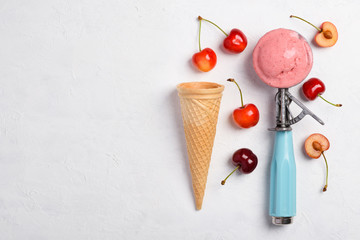 Cherry ice cream spoon with homemade icecram scoop with wafer cone on white table background...