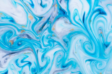 Marbled unique blue abstract background with gold dust. Flowing liquid marble texture.
