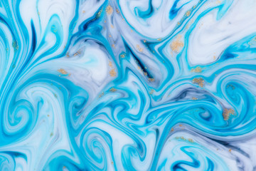 Marbled unique blue abstract background with gold dust. Flowing liquid marble texture.