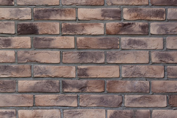Brick wall with spotted brown bricks. Used as a background.