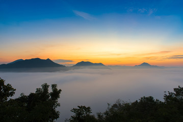 mountains under mist in the morning with sunrise at Phutoke Loei Thailand