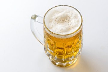 Beer mug. Mug of light fresh beer with foam and drops of water o
