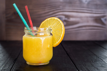 Fresh orange juice in glass on black background