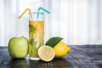 Refreshing lemonade with mint on glass on black background