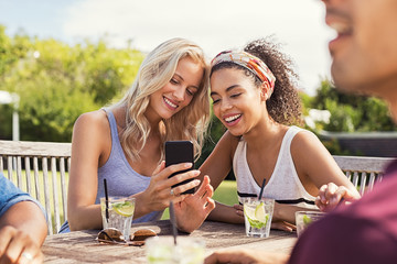 Friends smiling with smartphone