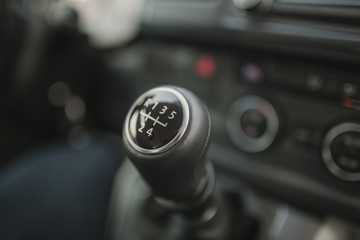 Close up of gear shift stick with 5 speed and reverse.