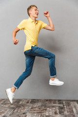 Full length portrait of a happy teenage boy running away