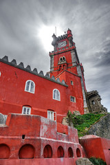 Obraz premium Palace da Pena tower over hill and sun
