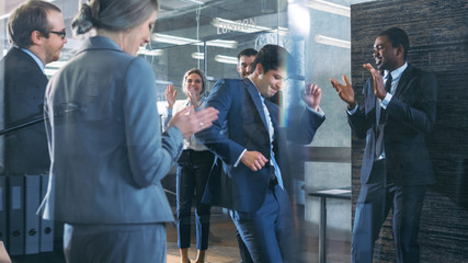 Diverse Group of Business People Celebrate Closing of the Deal and Dance. Funny and Friendly Theme.
