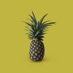 Pineapple fruit isolated on yellow background with clipping path