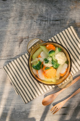 Assorted vegetables in glass pot on a napkin close up