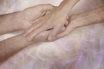 Giving a gentle blessing - cupped male hands being held and blessed by female hands on a wispy smoke effect background and copy space below
 - obrazy, fototapety, plakaty
