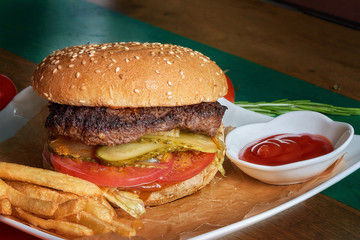 Delicious appetizing hamburger in the cafe. Fast food.