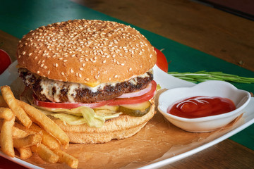 Delicious appetizing hamburger in the cafe. Fast food.