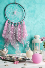 Dream catcher on aquamarine wall background