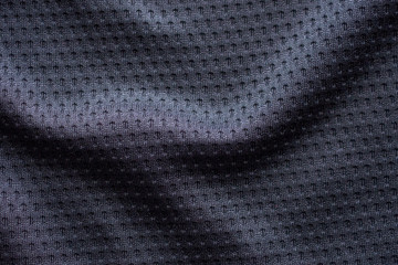 Fototapeta na wymiar Black fabric sport clothing football jersey with air mesh texture background