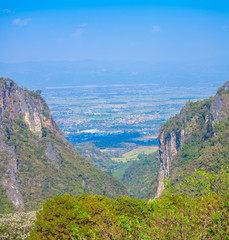 Fototapeta na wymiar panorama at Doi Pha Mee view point you can see Doi Nangnon in Maesai Chiang Rai shape of mountains look like women sleeping. inside of Doi Nang Non have big and long cave childrens lost in this cave.