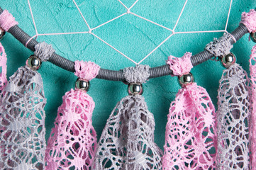 Dream catcher on aquamarine wall background