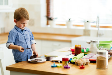 Cute child learning to become a chef