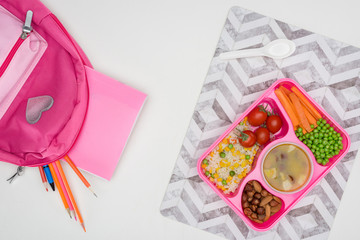 Fototapeta na wymiar top view of tray with kids lunch for school and copybooks on wooden table
