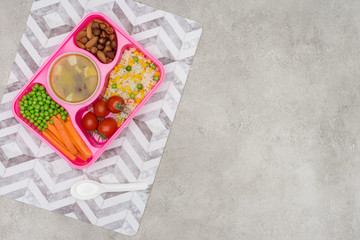 top view of tray with kids lunch for school on napkin on marble table
